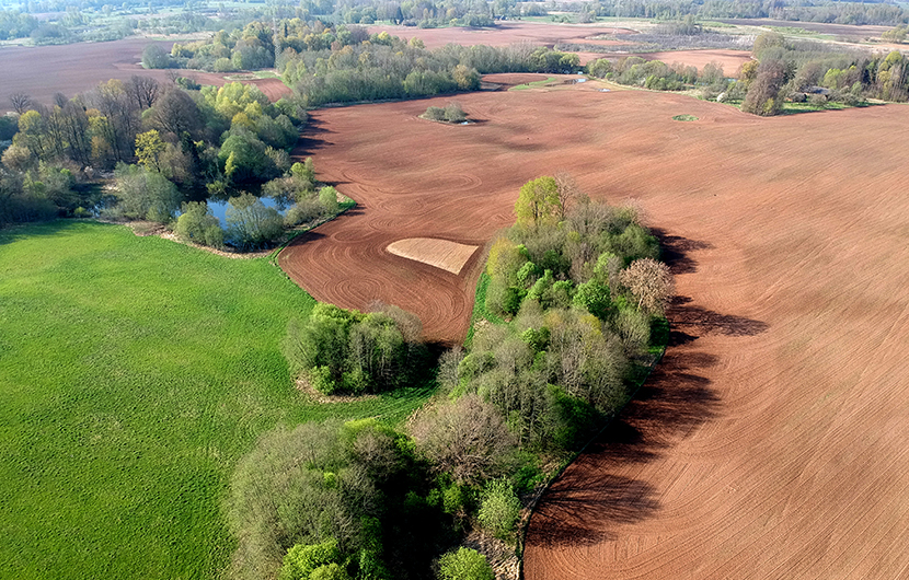 shutterstock-photo-beautiful-spring-farmland-landscape-with-fields-groves-and-pond-aerial-view-1170457513_HD